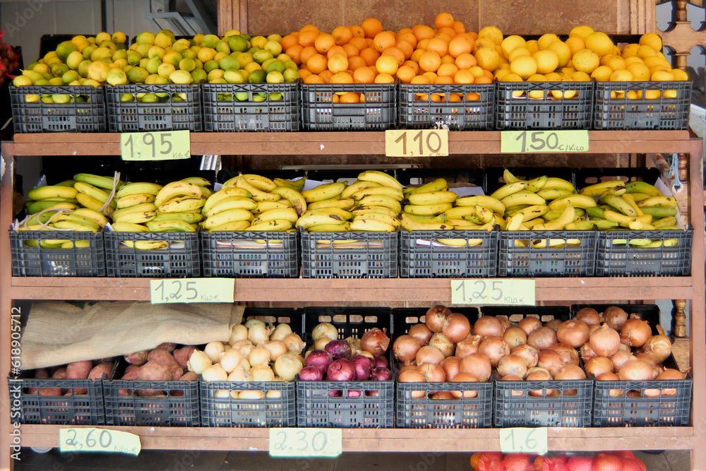 Vibrant Street Market: Colorful display of bananas, onions, potatoes, lemons and oranges at a fruit stall.
