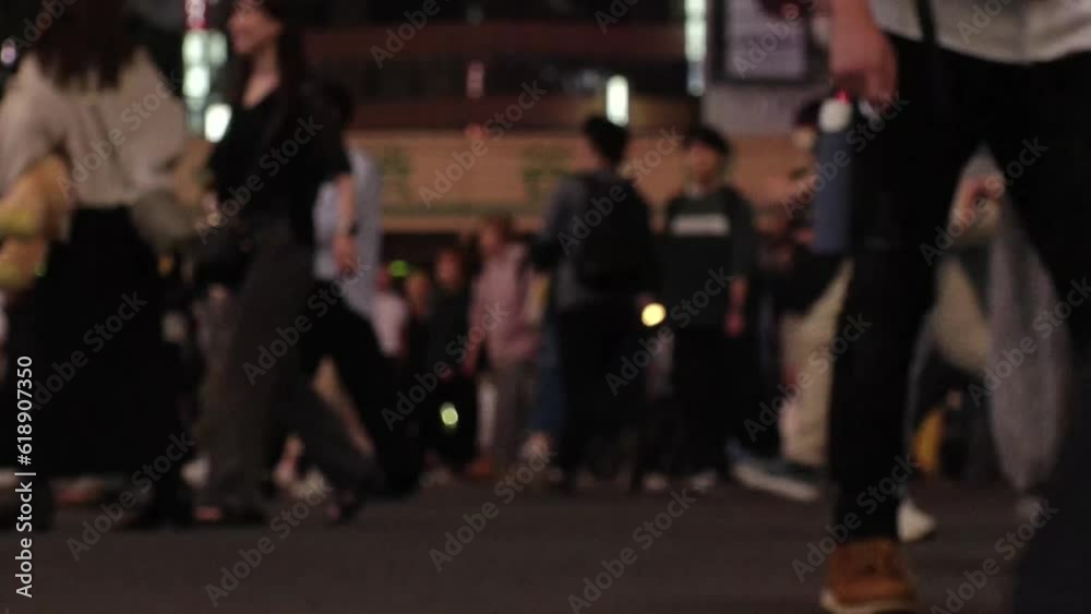 SHIBUYA, TOKYO, JAPAN - JUNE 2023 : View of crowd of people walking around SHIBUYA STATION at night. Busy downtown area in Tokyo. Japanese people, city life and traffic concept video. Time lapse shot. SHIBUYA, TOKYO, JAPAN - JUNE 2023 : View of crowd of people walking around SHIBUYA STATION at night. Busy downtown area in Tokyo. Japanese people, city life and traffic concept video. Time lapse shot.