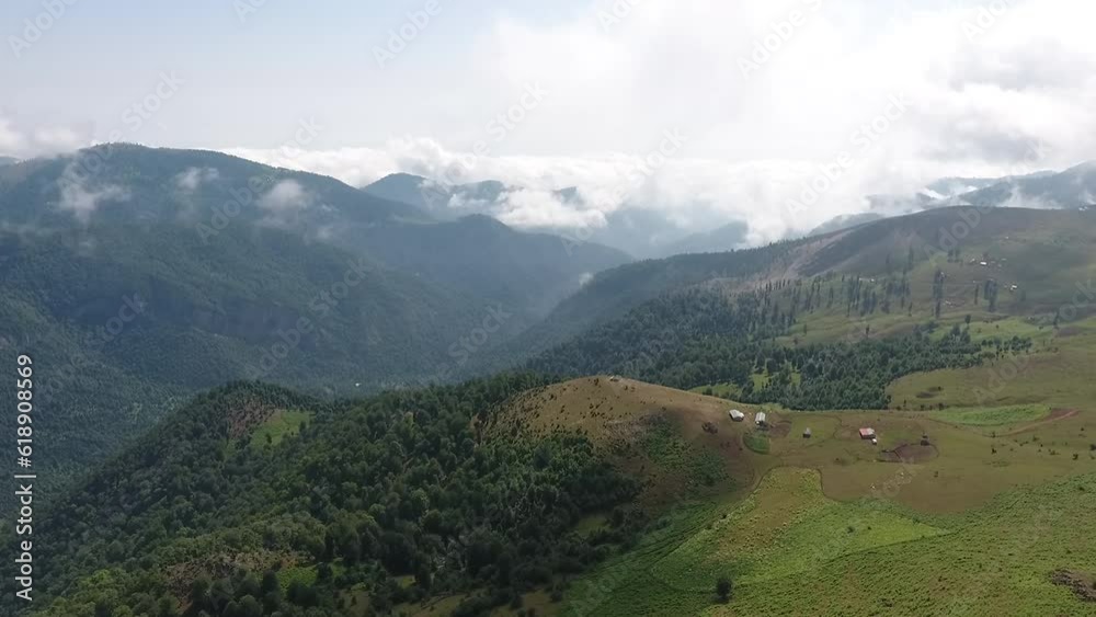 A bird's-eye view of distant mountains covered in fog and beautiful sunlight.