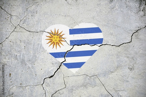 The symbol of the national flag of Uruguay in the form of a heart on a cracked concrete wall.