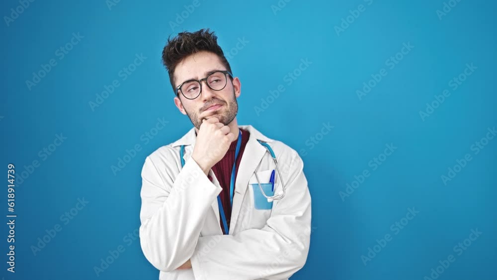 Young hispanic man doctor standing with doubt expression thinking over isolated blue background Young hispanic man doctor standing with doubt expression thinking over isolated blue background