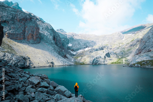 Back shot of an adventurer by glacier lake