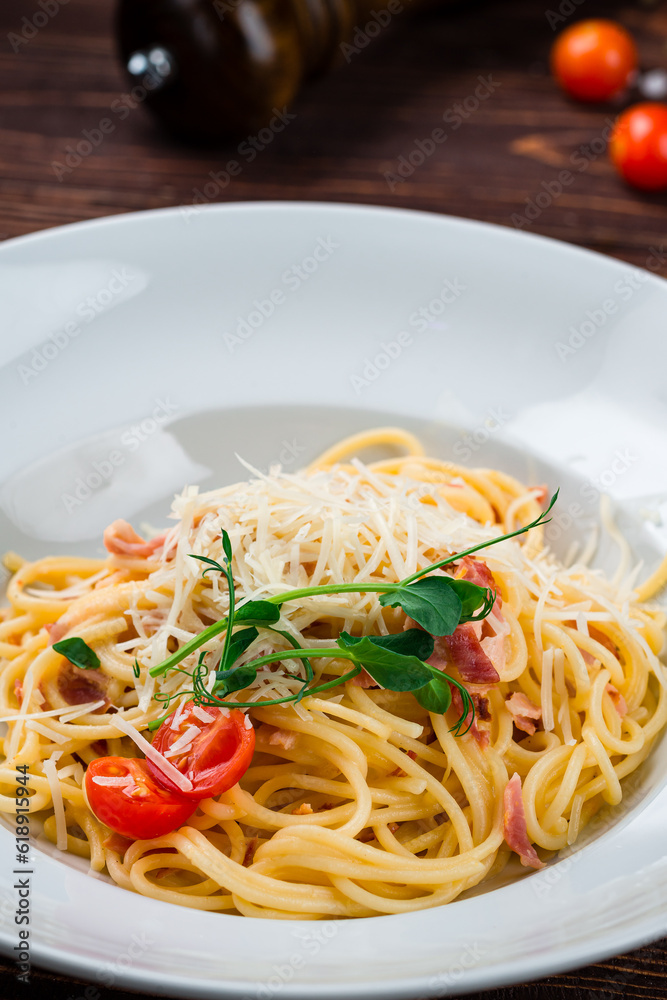 Spaghetti with bacon, cherry tomatoes, parmesan cheese and herbs, closeup. Spaghetti with bacon, cherry tomatoes, parmesan cheese and herbs, closeup.