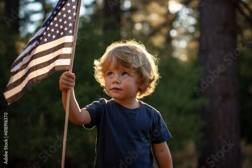 A boy with the US flag at the celebration of the Independence Day of the United States of America photo