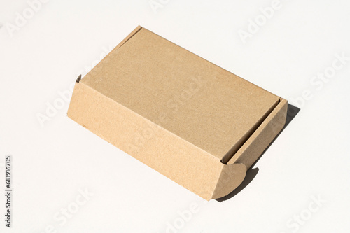 Rectangular closed box made of corrugated cardboard on a white background © Julia Jones