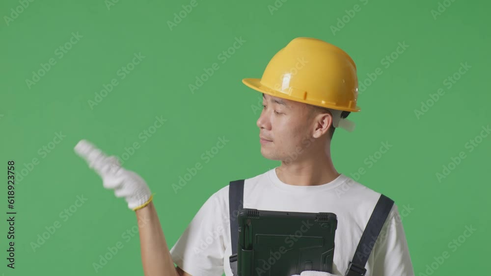 Close Up Of Asian Man Painter Wearing Safety Helmet Using A Tablet And Pointing To Side While Standing In The Green Screen Background Studio
Close Up Of Asian Man Painter Wearing Safety Helmet Using A Tablet And Pointing To Side While Standing In The Green Screen Background Studio