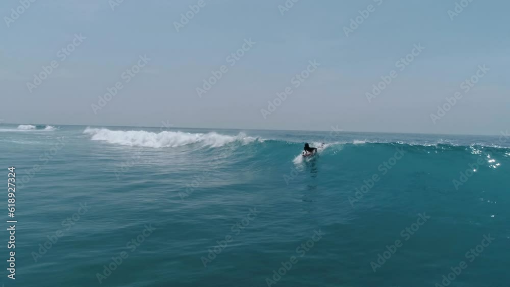 Surfing in Asia side. Powerful ocean and one man alone do workout with surf barreled at big waves. Beautiful beachscape Surfing in Asia side. Powerful ocean and one man alone do workout with surf barreled at big waves. Beautiful beachscape