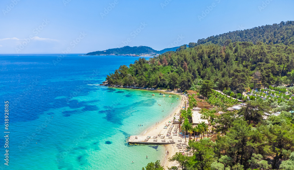 Beach and turquoise sea, palm trees. La Scala Beach, Thassos, Greece