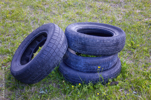 Pile of tires dump. Illegal garbage dump. The concept of ecology pollution.