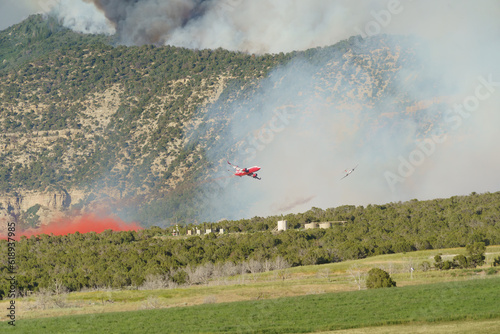 VLAT (very large air tanker) make a retardant drop on a wildfire photo
