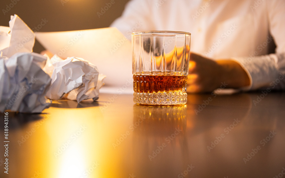 Close up of businessmen holding a glass of whiskey Close up of businessmen holding a glass of whiskey