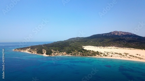 beautiful aerial view from the Atlantic towards the huge Dunes of Valdevaqueros with forest  mountains and rocks in the background  Tarifa  Andalusia  province of C  diz  Spain