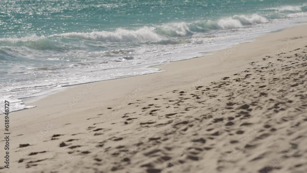 Slow motion clear blue waves with strong wind on a sandy empty beach in Cannes in spring Slow motion clear blue waves with strong wind on a sandy empty beach in Cannes in spring