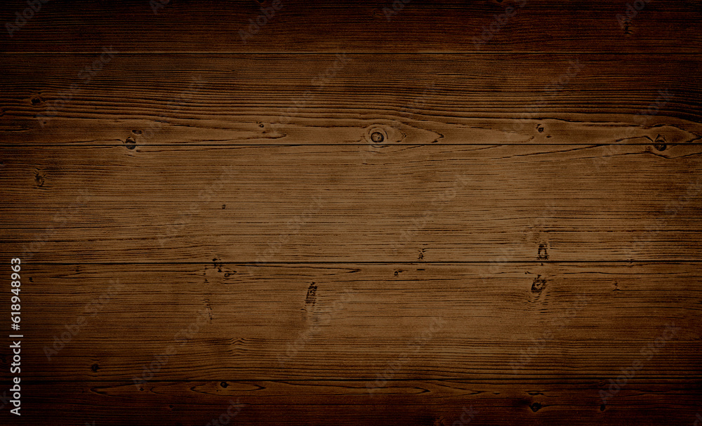 Dark stained reclaimed wood surface with aged boards lined up. Wooden