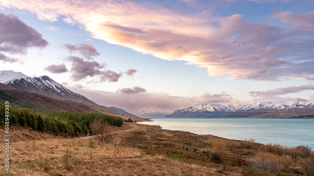 Scenic view at Peters Lookout, Mount Cook Road alongside Lake Pukaki with snow capped Southern Alps basking in the late winter evening light. Best road trip route in New Zealand Southern Island.