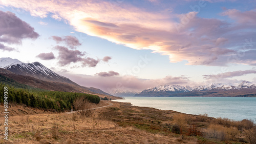 Scenic view at Peters Lookout, Mount Cook Road alongside Lake Pukaki with snow capped Southern Alps basking in the late winter evening light. Best road trip route in New Zealand Southern Island.