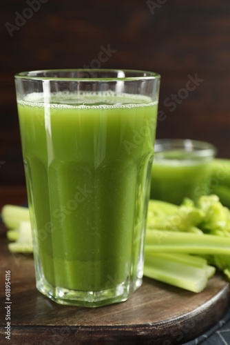 Glasses of delicious celery juice and vegetables on wooden board
