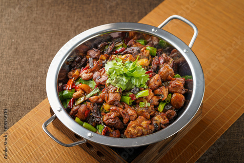 Special Sichuan cuisine griddle chicken on dark background