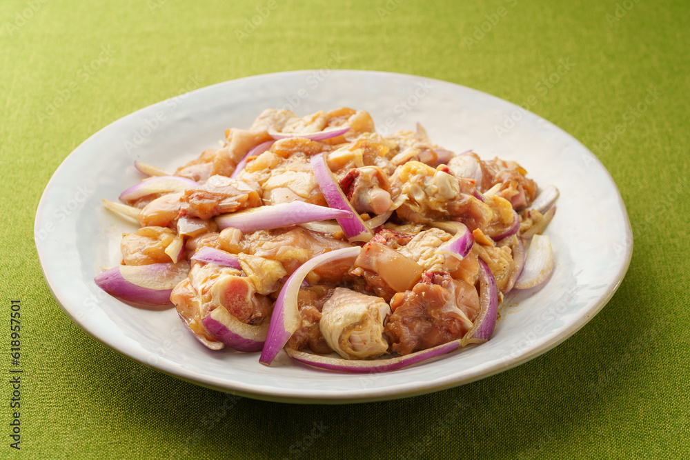 Fresh chicken thigh pieces on a monochrome background Fresh chicken thigh pieces on a monochrome background