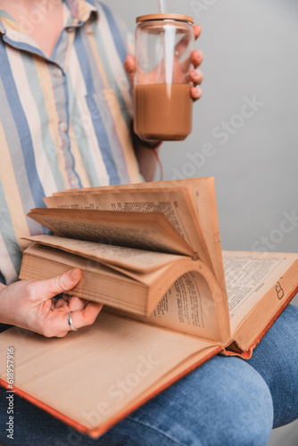 woman reading a book and drinking coffee