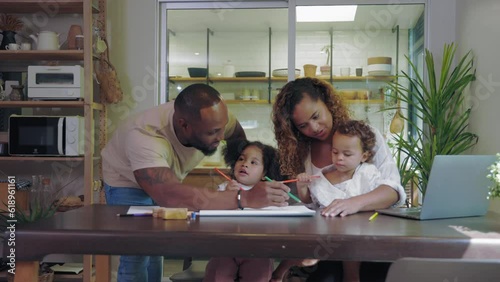 African father and mother painting with child