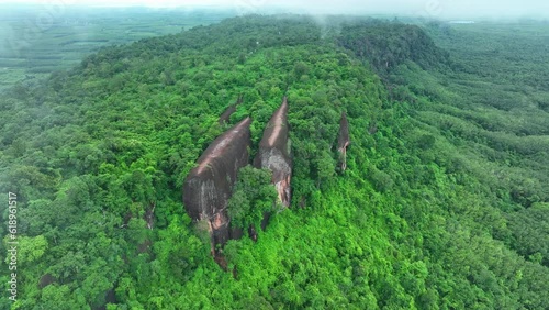 aerial view of Hin Sam Wan which is covered with green trees and there is a light mist photo