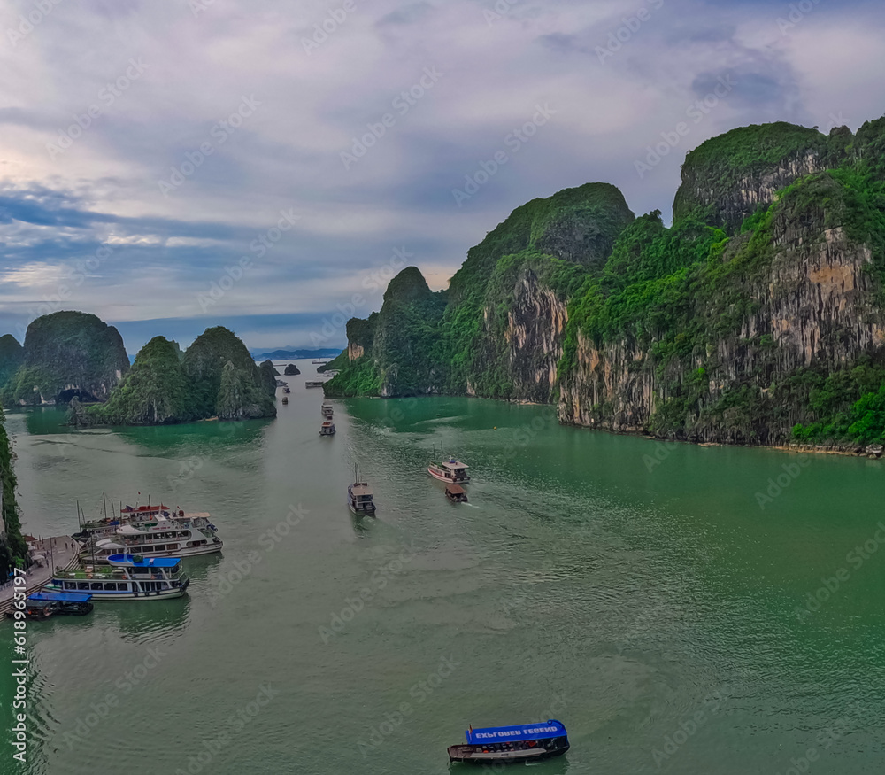 Ha Long Bay littered with mountains and Rock cliffs popping out of the ocean, lush green mountains in Vietnam