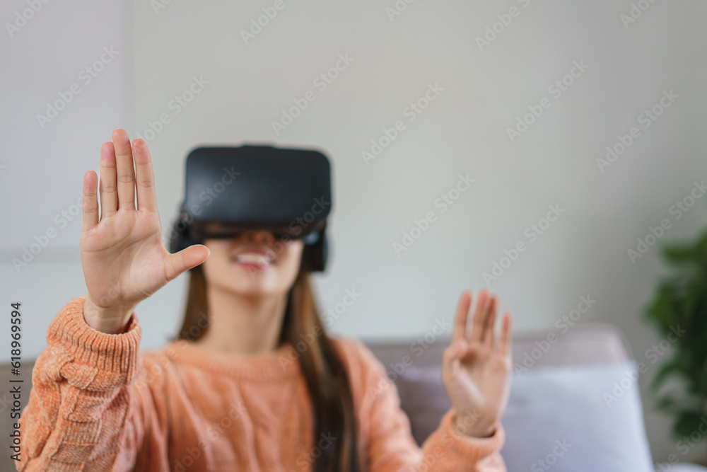 Women enjoying experience with virtual reality goggles to watching video games in lifestyle at home Women enjoying experience with virtual reality goggles to watching video games in lifestyle at home
