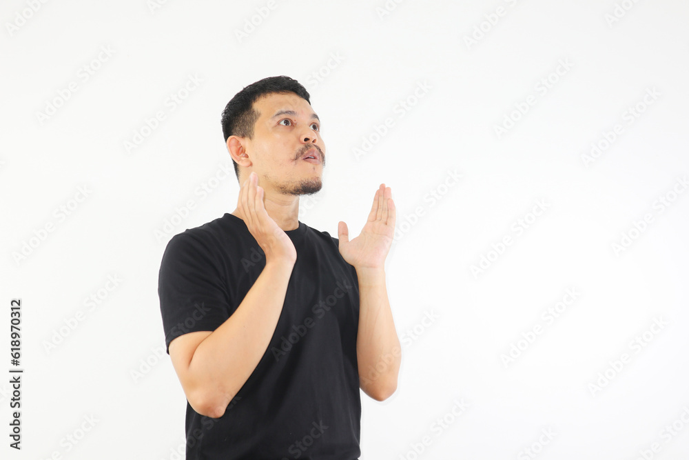 an asian man showing shocked face and looking upside an asian man showing shocked face and looking upside