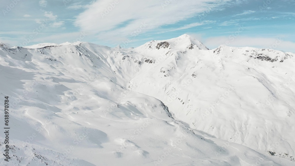 Snow mountain range landscape on winter sunny day. Beautiful panorama of European Alps video from drone. Aerial of panoramic view of snowy mountains at alpine ski resort in Livigno, Italy 