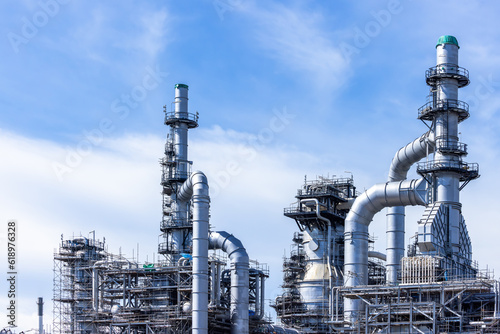 Oil and gas industrial with blue sky background, Oil refinery plant form industry zone, Refinery factory oil storage tank and pipeline steel.