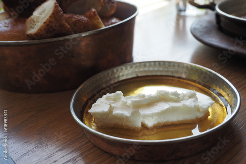 butter cream and honey in a bowl on table .