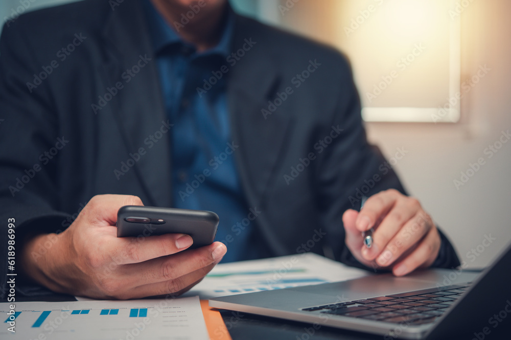Businessman Analyzing data on laptop and graph chart for financial planning report diagram marketing on desk. Businessman Analyzing data on laptop and graph chart for financial planning report diagram marketing on desk.