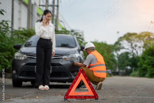 Traffic accident, insurance agent inspects damaged vehicles and submits a post-accident claim report, insurance concept