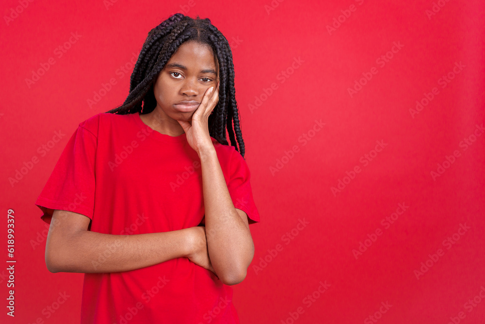 Bored african woman standing and looking at camera Bored african woman standing and looking at camera
