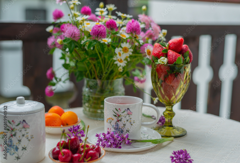 Morning tea with flowers and fruits on the terrace of a country house. Morning tea with flowers and fruits on the terrace of a country house.