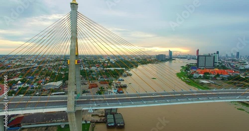 Aerial View of Bangkok and the Bhumibol Bridge inter-city expressway .Across the Chao Phraya River and ring road systems on the outer edge of Bangkok Metropolitan..beautiful King Bhumibol suspension b photo