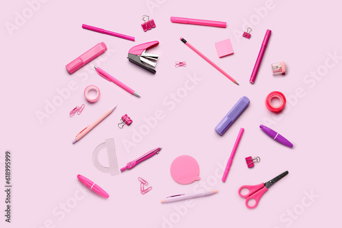 Frame made of stationery supplies on pink background