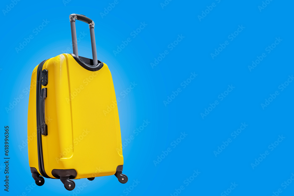 Yellow suitcase on a blue background. Travel concept. isolated Yellow suitcase on a blue background. Travel concept. isolated