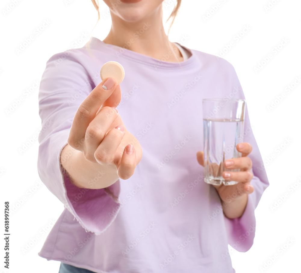 Young woman with soluble tablet and glass of water on white background, closeup Young woman with soluble tablet and glass of water on white background, closeup