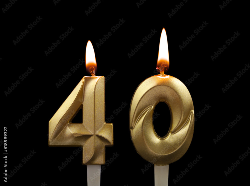 Burning gold birthday candles isolated on black background. Number 40. Burning gold birthday candles isolated on black background. Number 40.