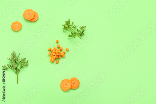 Slices of fresh carrots green background