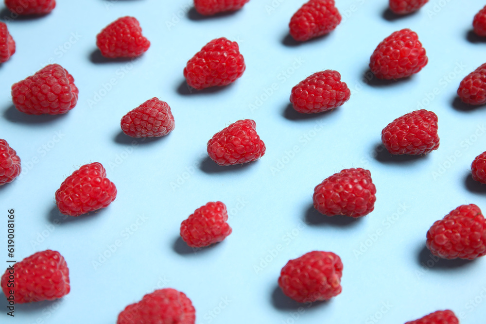Many fresh raspberries on blue background Many fresh raspberries on blue background