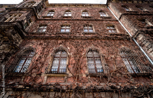 Facade of a old european historical building with vintage windows and doors © romaset