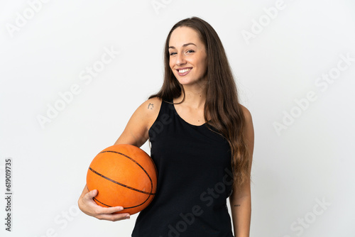 Young hispanic woman over isolated white background playing basketball