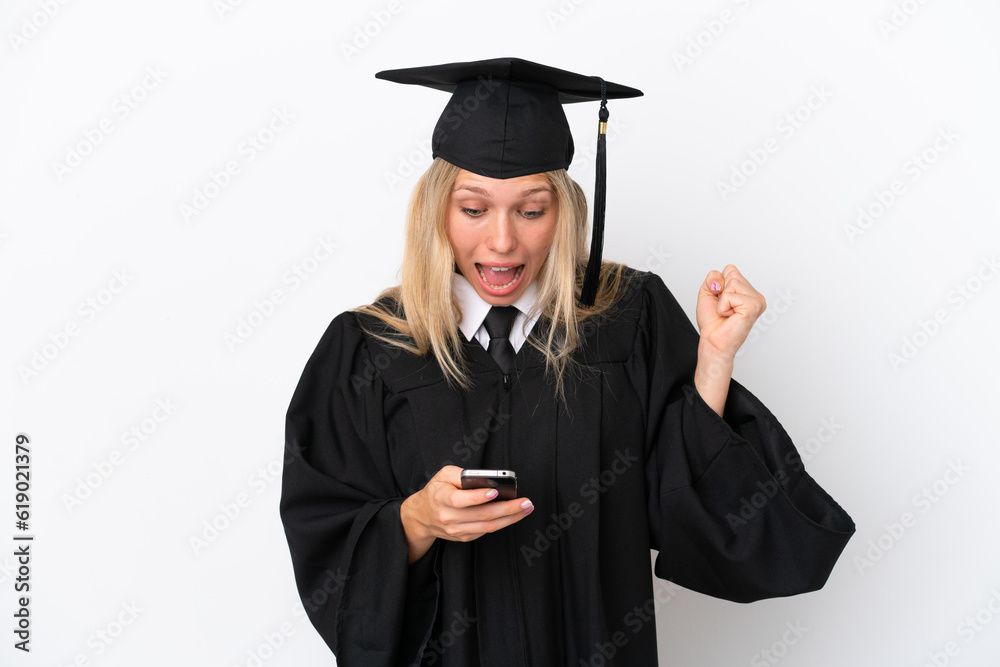 Young university graduate caucasian woman isolated on white background surprised and sending a message Young university graduate caucasian woman isolated on white background surprised and sending a message