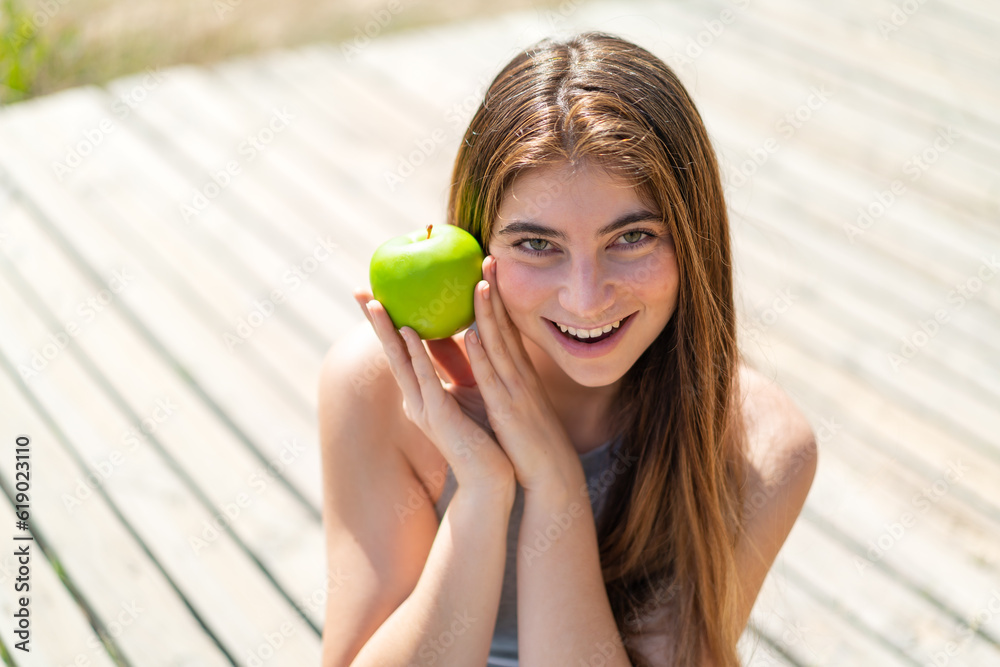 Young pretty caucasian woman holding an apple Young pretty caucasian woman holding an apple