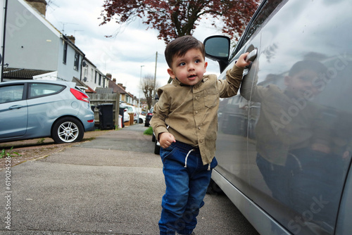 Cute Asian Pakistani Male Baby Boy is Posing on Local Street of Luton City of England UK. The Image Was Captured on April 3rd, 2023. His Name is Ahmed Mustafain Haider. photo