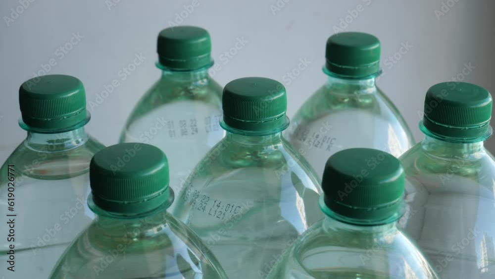 Circular conveyor at production of drinking water with spinning full bottles with long lasting water detailed video in 4K resolution Circular conveyor at production of drinking water with spinning full bottles with long lasting water detailed video in 4K resolution
