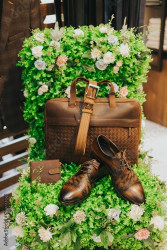 Closeup of a pair of classic Oxford shoes with a wallet and a bag in a boutique photo